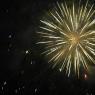 Bright white explosion as a firework goes off in the night sky.