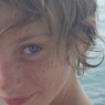Z's face cropped against sea background