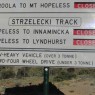 Sign in the Australian outback, indicating that roads to and from Mount Hopeless are closed.