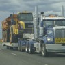 big truck carrying industrial machinery in outback australia