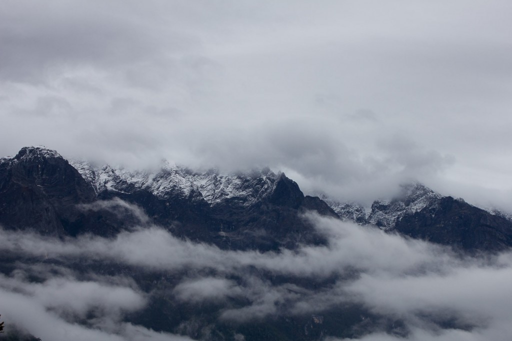 Snow and clouds wreath the peaks of Jade Dragon Snow Mountain in Tiger Leaping Gorge.
