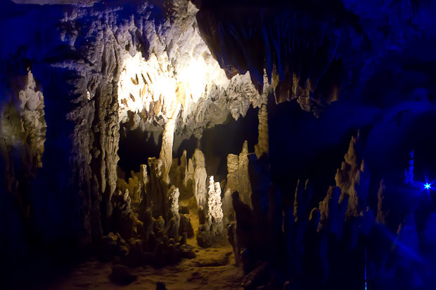 Konglor Cave Laos Chamber of stactites and stalagmites illuminated blue in the Konglor Cave, Laos.