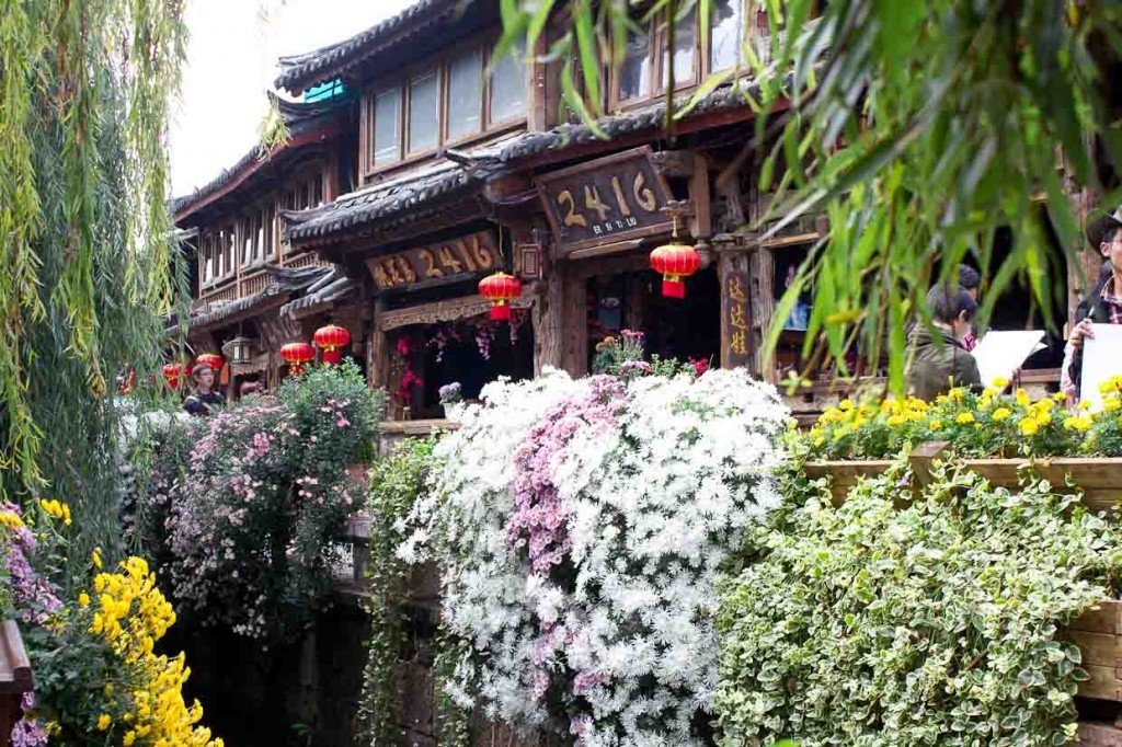 Shophouses and flowers in Lijiang, China.
