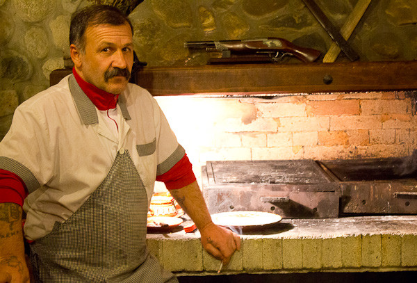 Man with moustache Moustachioed cook smoking in Bulgarian mekhana.