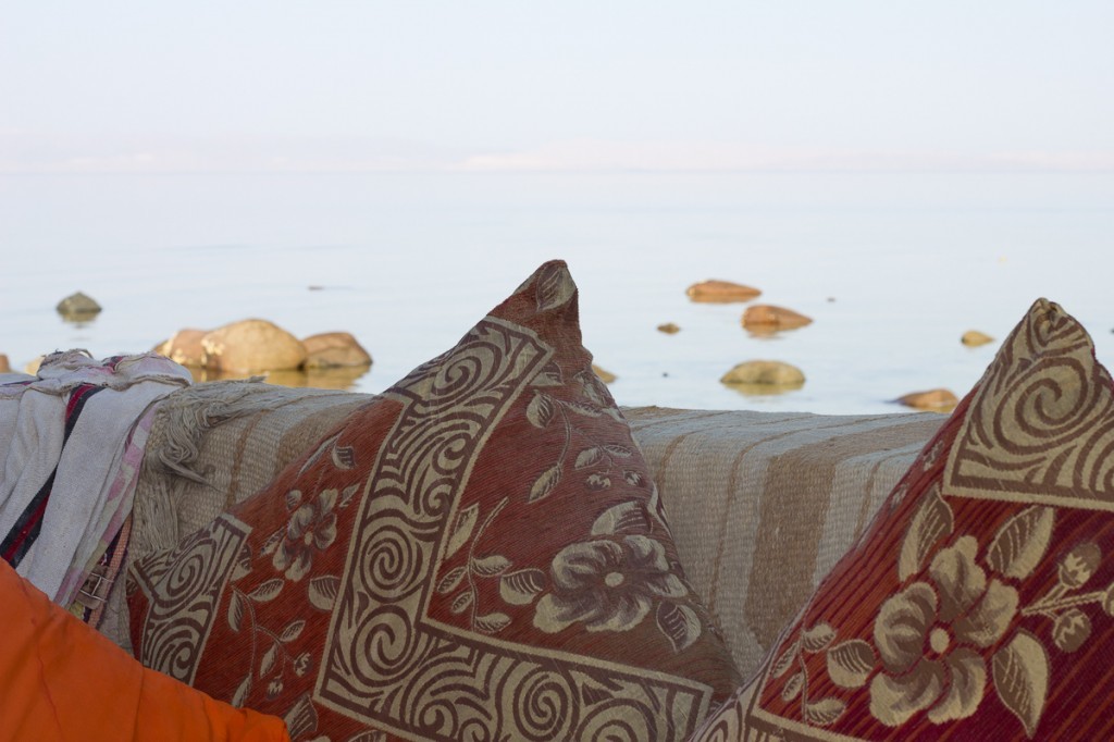 Cushions and rocks leading out to sea in Dahab, Egypt.