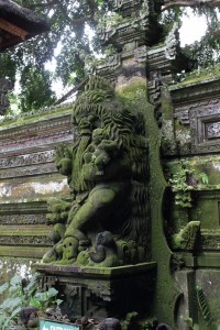 Statue of Siwa on Balinese temple, with skulls and babies under his feet