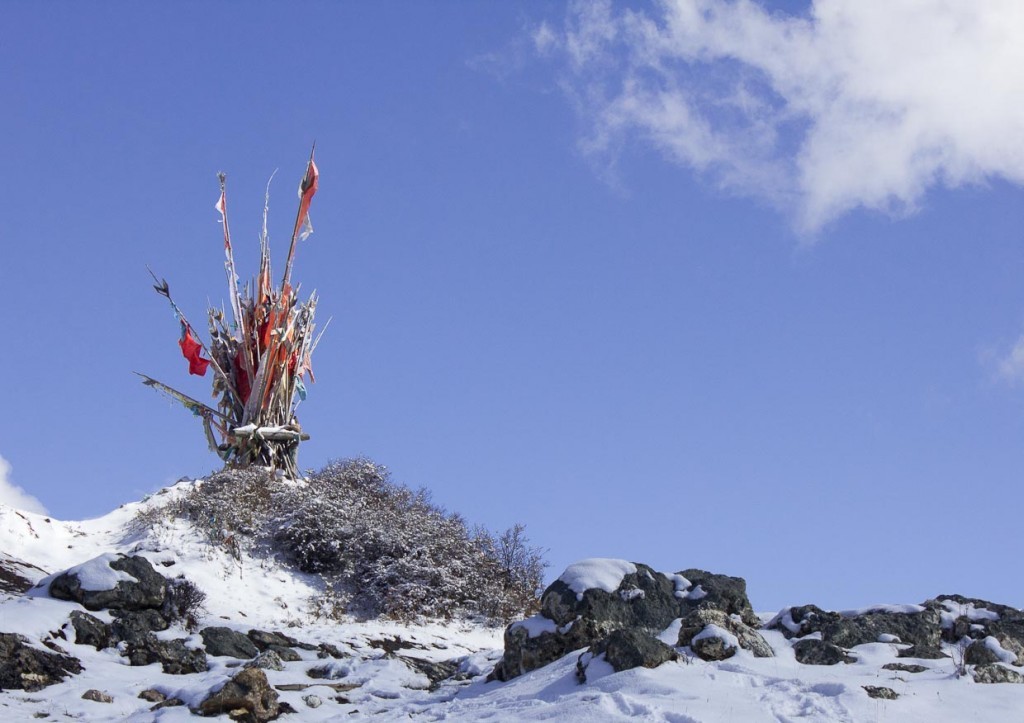 Horse trekking Songpan: flags in snow in the mountains