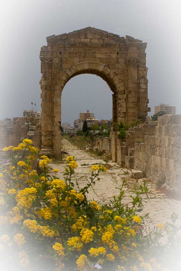 Tyre-8 Triumphal arch at Al-Bass archaeological site, Tyre, framed by flowers.