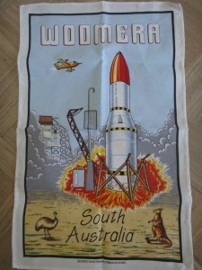Tea towel featuring a missile launching, branded Woomera, South Australia