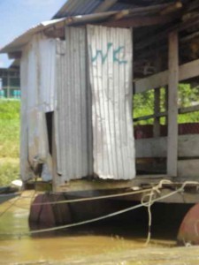 corrugated iron WC over the water in rural Borneo