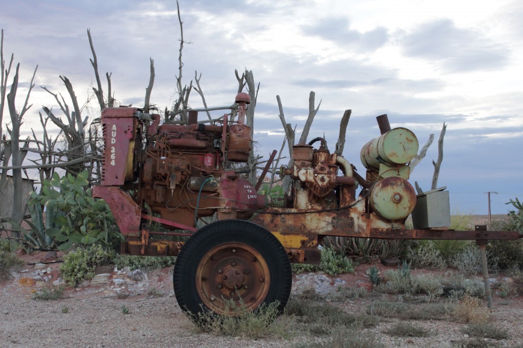mining machinery against dead wood, coober pedy, south australia