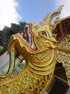 Gilded and glasswork dragon/naga guarding a temple.