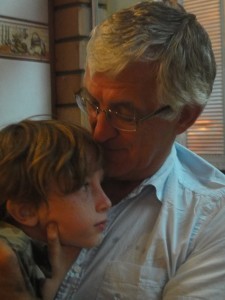 Z having a cuddle with his grandfather on his grandparents' last night in Borneo.