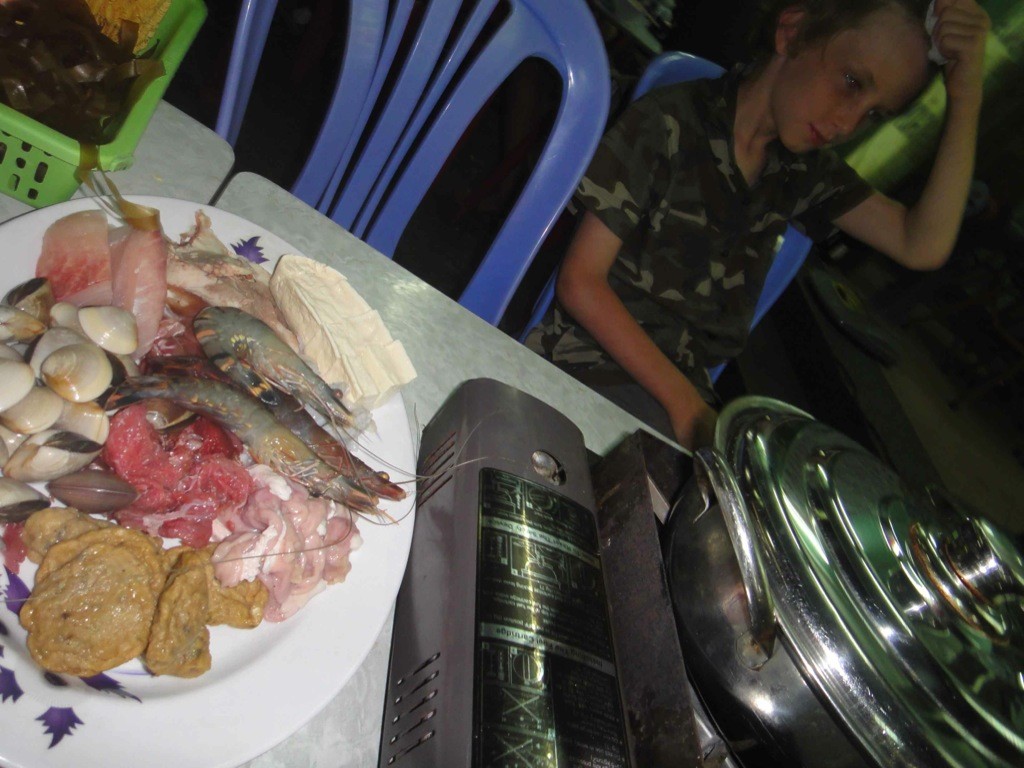 hot_pot_cam_chi_alley_hanoi_vietnam hot pot on tabletop with plate of meat beside it. Cam Chi alley, Hanoi, Vietnam