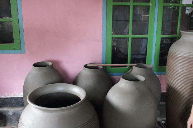 pottery against pink clay pots drying against a pink wall