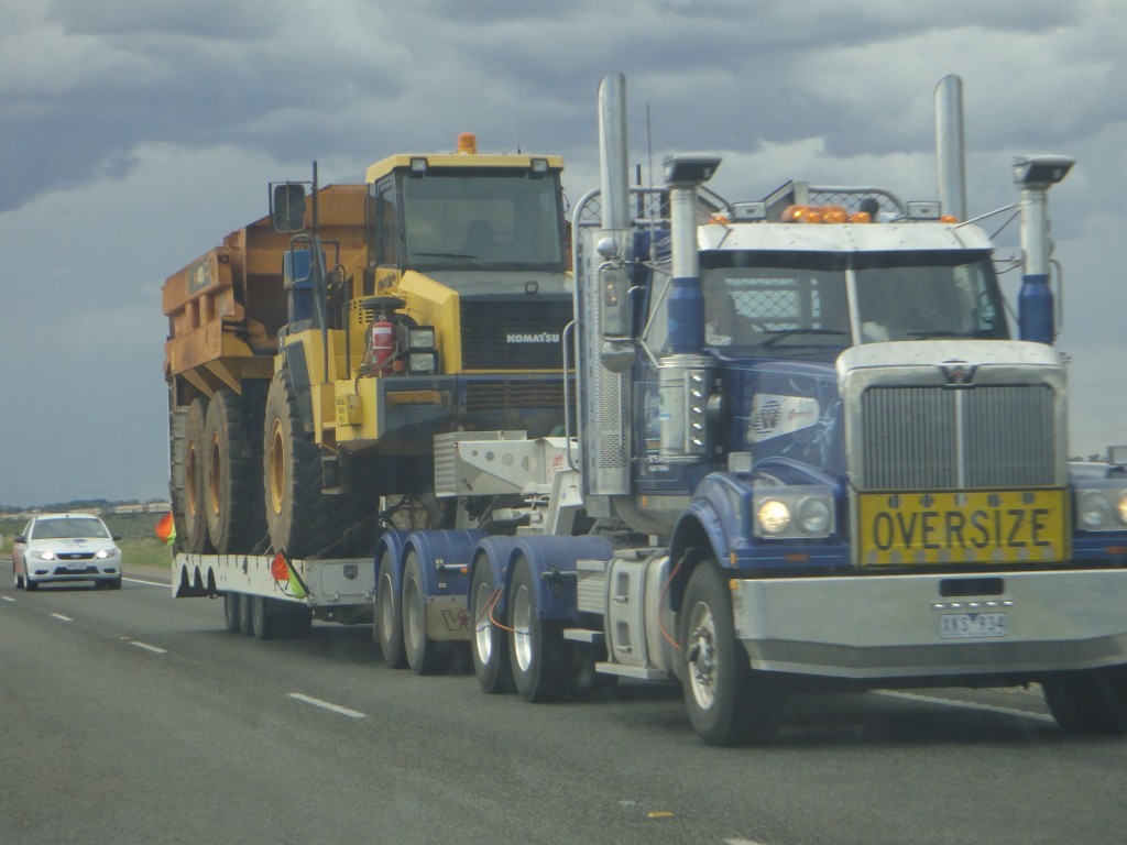 big truck carrying industrial machinery in outback australia