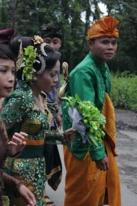 sasak bridal party, spangled and green, heading out to a wedding in pejunjak, lombok
