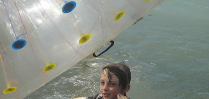 Z in lake with zorb (xorb) ball floating besides him. X-Centre, Chiang Mai, Thailand.