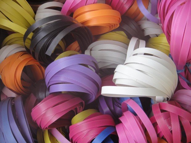 Brightly coloured spirals of plastic packing tape on sale individually. Belaga, Sarawak, Borneo, Malaysia.