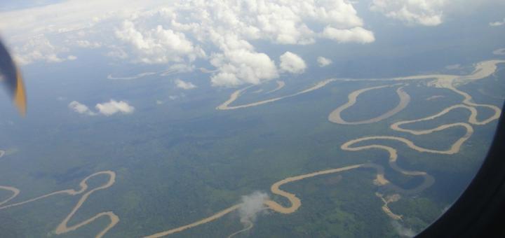 View from a low-flying prop plane over Mulu National Park and the Mulu River. Sarawak, Borneo, Malaysia.