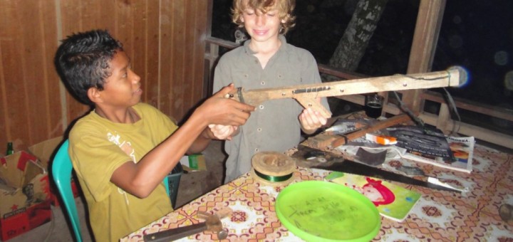 Amal shows Z the toy gun he has made. Pulau Kadidiri, Indonesia.