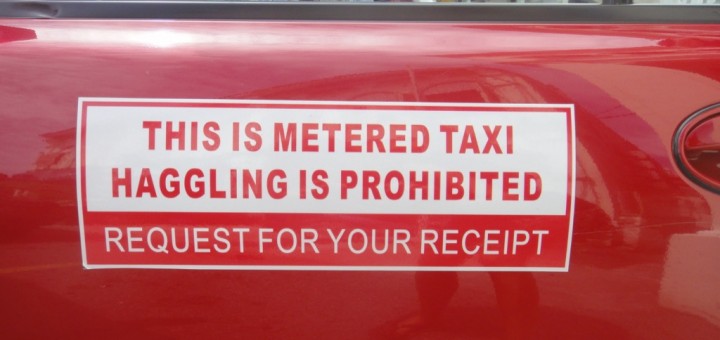 taxi reading "this is metered taxi. haggling is prohibited."