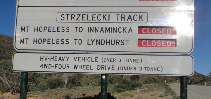 Sign in the Australian outback, indicating that roads to and from Mount Hopeless are closed.