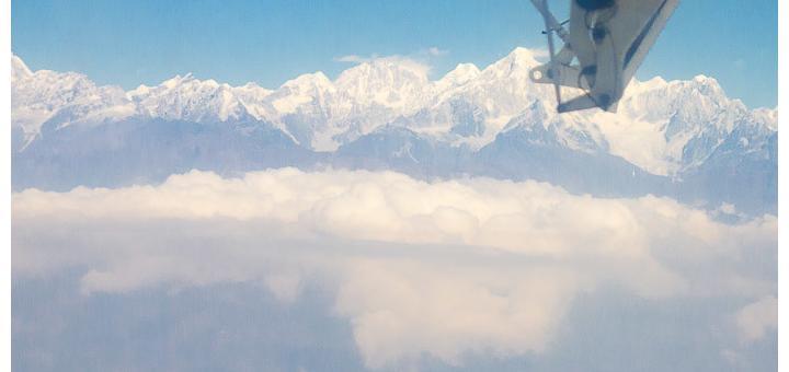 Flying into Lukla - Twin Otter wing over Himalayas.