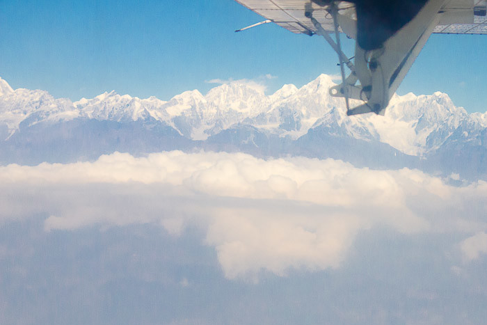 Flying into Lukla - Twin Otter wing over Himalayas.