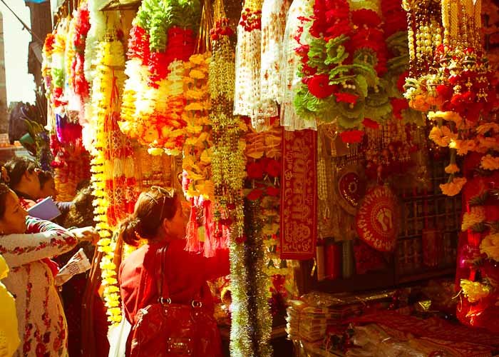 Women shopping for offerings in Kathmandu, Nepal.