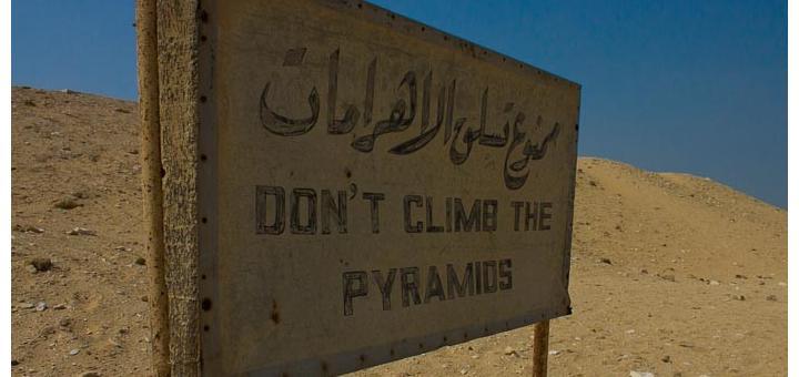 Sign reading - 'Don't climb the pyramids.'