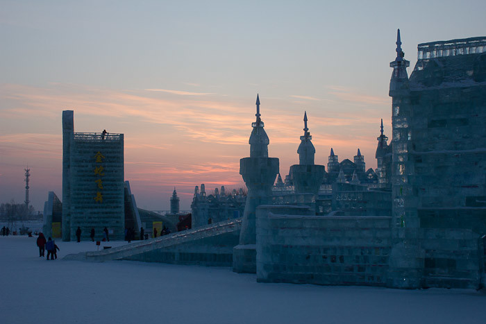 Sun sets over ice palaces in Harbin.