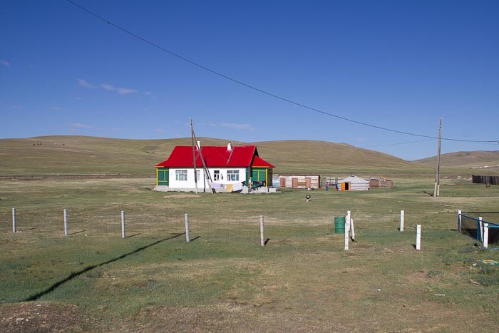 Mongolian homestead with gers in the background.
