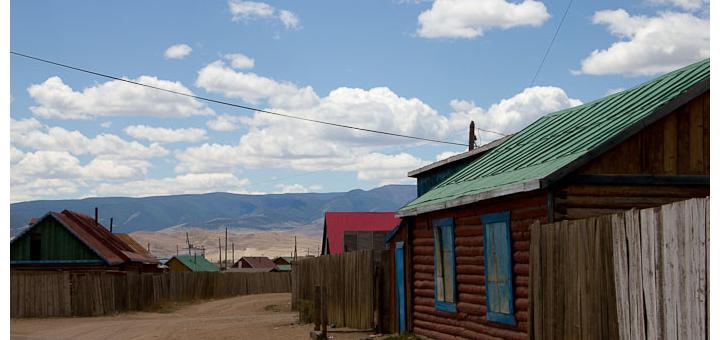 View of log cabins, sand and nothing, Mörön, Mongolia.