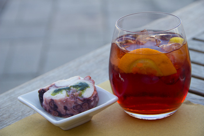 Negroni cocktail and octopus cicheti.
