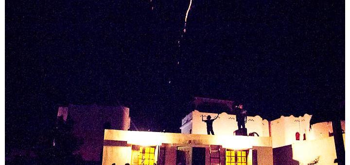 Zac and Tyler setting off fireworks on the roof of our house.