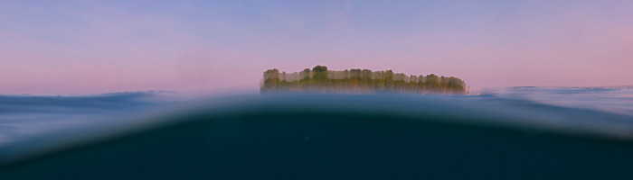 Kakaban island in Borneo's Derawan Archipelago, blurred in a wave.
