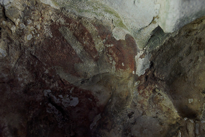 Hand stencil in the Leang-Leang caves of Maros, with truncated ring finger.