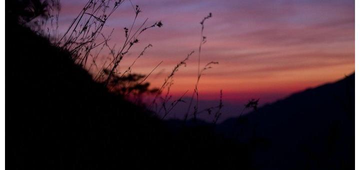 The sun makes its first appearance, midway up Mount Batur, Bali.