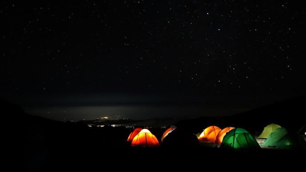 Tents glowing at night on Kilimanjaro