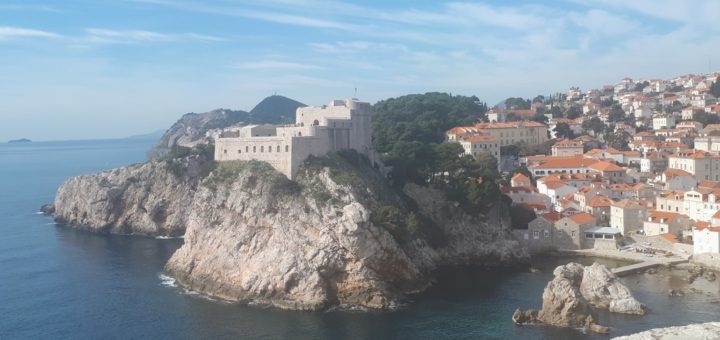 Lovrijenac Fortress in Dubrovnik with red tiled houses behind.