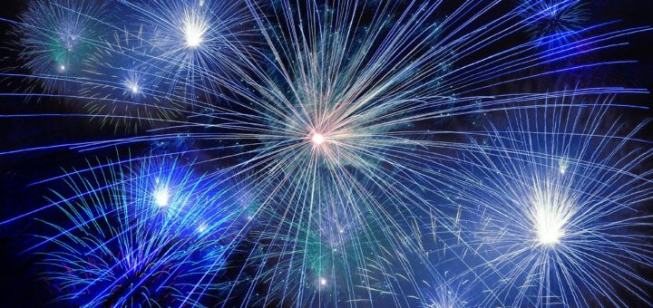 blue fireworks explode in the sky on new year's eve