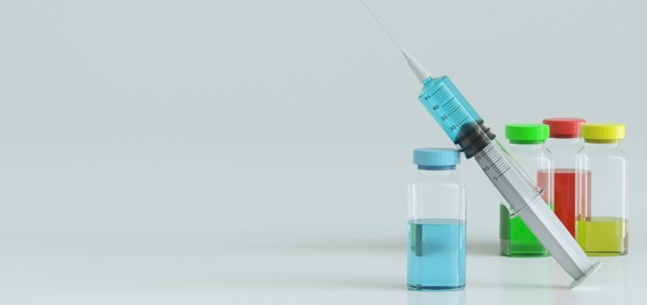 syringe with vials of coloured liquid